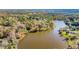 Wide aerial view of a vast lake surrounded by lush trees, showcasing the property's secluded and natural setting at 205 Pine Knott Rd, Fayetteville, GA 30214