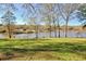 Lush backyard with access to a serene lake and mature trees creating a peaceful setting at 205 Pine Knott Rd, Fayetteville, GA 30214