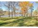 Lush backyard with a swing set and stunning lake views, perfect for recreation at 205 Pine Knott Rd, Fayetteville, GA 30214