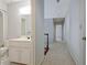 Hall bathroom with a single sink vanity, tile floors, and a shower-tub combo at 205 Pine Knott Rd, Fayetteville, GA 30214