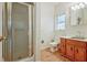 Bright bathroom featuring a glass-enclosed shower, vanity and wood-look flooring at 205 Pine Knott Rd, Fayetteville, GA 30214