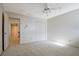 Bedroom view with carpet floors, a ceiling fan, and a double door closet at 205 Pine Knott Rd, Fayetteville, GA 30214