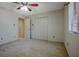 Bedroom featuring a carpet floor, ceiling fan, a closet, and neutral walls at 205 Pine Knott Rd, Fayetteville, GA 30214