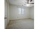 This bedroom features neutral walls, a ceiling fan and a window that allows for natural light to fill the room at 205 Pine Knott Rd, Fayetteville, GA 30214