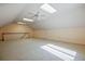 This bonus room features carpeted floors, skylights, windows, and ceiling fans for comfort at 205 Pine Knott Rd, Fayetteville, GA 30214
