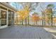 Outdoor deck with railings overlooking a picturesque lake and fall foliage at 205 Pine Knott Rd, Fayetteville, GA 30214