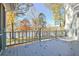 The deck offers ample space for outdoor activities and views of the surrounding landscape and tranquil lake at 205 Pine Knott Rd, Fayetteville, GA 30214