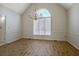 Formal dining room with wood floors, chandelier, and large arched window at 205 Pine Knott Rd, Fayetteville, GA 30214