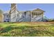 Rear exterior featuring a screened porch, a large deck and a well-manicured lawn at 205 Pine Knott Rd, Fayetteville, GA 30214