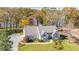 Landscaped home featuring lake views, a gray roof, and a manicured front yard at 205 Pine Knott Rd, Fayetteville, GA 30214