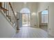 Bright and open foyer with tile floors, arched windows, and staircase on the left at 205 Pine Knott Rd, Fayetteville, GA 30214