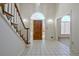 This bright foyer offers tile flooring, an arched doorway and a beautiful stained glass window above the door at 205 Pine Knott Rd, Fayetteville, GA 30214