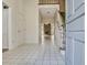 Open foyer featuring white tile flooring, a staircase, and a view to the living room at 205 Pine Knott Rd, Fayetteville, GA 30214
