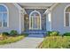 Covered front entrance with stone accents, arched windows, and a flagstone walkway at 205 Pine Knott Rd, Fayetteville, GA 30214
