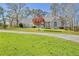 Well-maintained home featuring a manicured lawn, beautiful landscaping, and a long driveway leading to a picturesque residence at 205 Pine Knott Rd, Fayetteville, GA 30214