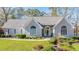 Beautiful single-story home showcasing arched windows, stone detailing, and mature landscaping at 205 Pine Knott Rd, Fayetteville, GA 30214