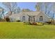 Charming front exterior with arched windows, stone accents, a lush lawn, and a welcoming curb appeal at 205 Pine Knott Rd, Fayetteville, GA 30214
