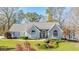 Beautiful single-story home featuring a stone facade, arched windows, and a well-maintained lawn at 205 Pine Knott Rd, Fayetteville, GA 30214