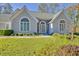 Charming front exterior featuring large windows, a stone facade, and manicured lawn at 205 Pine Knott Rd, Fayetteville, GA 30214