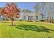 Charming single-story home featuring arched windows, stone accents, and a well-manicured lawn at 205 Pine Knott Rd, Fayetteville, GA 30214
