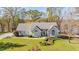Inviting home featuring professional landscaping, lush lawn, and proximity to a serene lake at 205 Pine Knott Rd, Fayetteville, GA 30214
