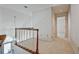 Upstairs hallway showcasing a carpeted floor and open railing looking to the foyer at 205 Pine Knott Rd, Fayetteville, GA 30214