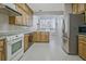 Well-lit kitchen features wood cabinets and stainless steel appliances at 205 Pine Knott Rd, Fayetteville, GA 30214