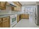 Spacious kitchen with plentiful wood cabinets and modern white appliances at 205 Pine Knott Rd, Fayetteville, GA 30214