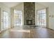 Bright living room with a striking floor-to-ceiling stone fireplace and beautiful hardwood floors at 205 Pine Knott Rd, Fayetteville, GA 30214
