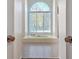 Spa-like main bathroom showcasing a large tub under a arched window and tile flooring at 205 Pine Knott Rd, Fayetteville, GA 30214