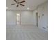 A carpeted main bedroom, brightened by a large window and featuring recessed lighting at 205 Pine Knott Rd, Fayetteville, GA 30214