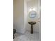 Stylish powder room features modern vessel sink, and a round mirror at 205 Pine Knott Rd, Fayetteville, GA 30214