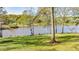 Scenic waterfront view showcasing lush green lawn, a tranquil lake, and a peaceful, natural setting at 205 Pine Knott Rd, Fayetteville, GA 30214