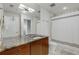 Modern bathroom with double sinks, marble countertops, and a shower at 3325 Piedmont Ne Rd # 1907, Atlanta, GA 30305