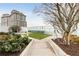 Rooftop dog park area with artificial turf, greenery, and a path, offering convenience for pet owners in the building at 3325 Piedmont Ne Rd # 1907, Atlanta, GA 30305