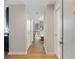 Hallway with hardwood floors leading to a bedroom with a crib at 3325 Piedmont Ne Rd # 1907, Atlanta, GA 30305