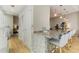 Spacious kitchen with a long island bar, granite countertops, and modern lighting at 3325 Piedmont Ne Rd # 1907, Atlanta, GA 30305