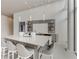 Modern kitchenette with stone counters, open shelving, and seating provides an elegant space for residents to gather at 3325 Piedmont Ne Rd # 1907, Atlanta, GA 30305