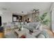 Inviting living room connected to the kitchen with a breakfast bar and bar stools at 3325 Piedmont Ne Rd # 1907, Atlanta, GA 30305