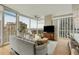 Bright living room with floor-to-ceiling windows offering panoramic city views and modern furniture at 3325 Piedmont Ne Rd # 1907, Atlanta, GA 30305