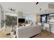 Open living area with modern decor, large windows, and a kitchen with an island bar at 3325 Piedmont Ne Rd # 1907, Atlanta, GA 30305