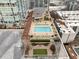 Aerial view of the rooftop pool and recreational area with lounge chairs, seating, and well-maintained landscaping at 3325 Piedmont Ne Rd # 1907, Atlanta, GA 30305