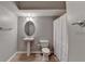 Bathroom with wood-look floors, neutral paint, a pedestal sink, and a toilet at 4032 Copper Creek Way, Buford, GA 30519