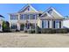 Beautiful exterior view featuring manicured bushes, dark shutters and complementary brick and siding at 4032 Copper Creek Way, Buford, GA 30519