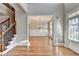 Inviting foyer with hardwood floors, staircase, and dining area with a chandelier and panel molding at 4032 Copper Creek Way, Buford, GA 30519