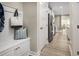 Hallway with coat rack and storage that leads into the home's kitchen and dining area at 1193 Burlington Ct, Mcdonough, GA 30253