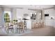 Bright and airy kitchen featuring white cabinetry and a dining area, perfect for gatherings at 1193 Burlington Ct, Mcdonough, GA 30253