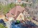 Aerial view of a well-maintained home showcasing stone and siding details, a large roof, and attached garages at 1526 Rocky River Dr, Lawrenceville, GA 30045