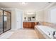 Bathroom featuring a large soaking tub, granite countertops, and a glass-enclosed shower at 1526 Rocky River Dr, Lawrenceville, GA 30045