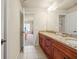 Spacious bathroom with double vanity and granite countertop leading into bedroom at 1526 Rocky River Dr, Lawrenceville, GA 30045